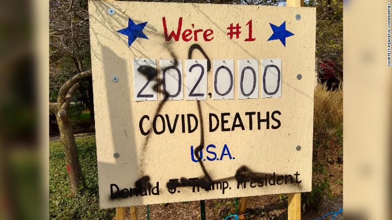 A sign reminding people of the 200,000 US Covid deaths vandalized five times in 6 days