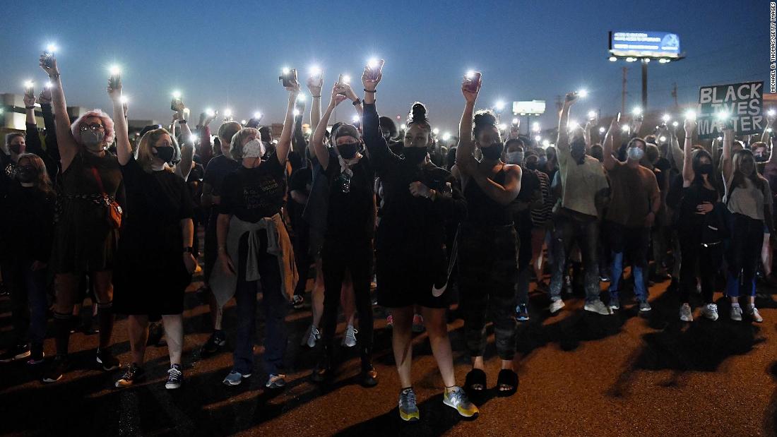 Protesters light up their cell phones during a demonstration on Interstate 64 in St. Louis, Missouri, on Thursday, September 24.