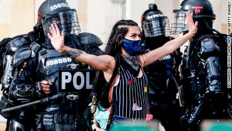 TOPSHOT - Riot police detain a demonstrator during protests against police brutality in Bogota on September 21, 2020. - Large groups of protesters are mobilizing in Colombia against police violence and in rejection of the government, after the bloody protests that unleashed the recent murder of a man at the hands of two uniformed men. (Photo by LEONARDO MUNOZ / AFP) (Photo by LEONARDO MUNOZ/AFP via Getty Images)