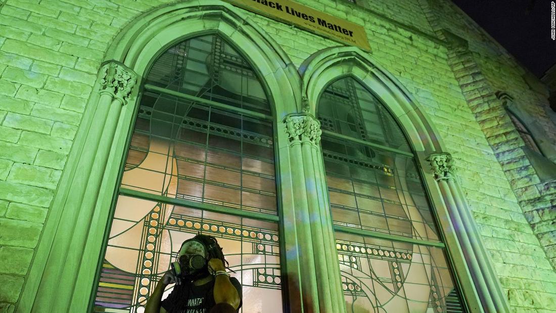 A protester wears a gas mask outside the First Unitarian Church on Thursday in Louisville, Kentucky. 