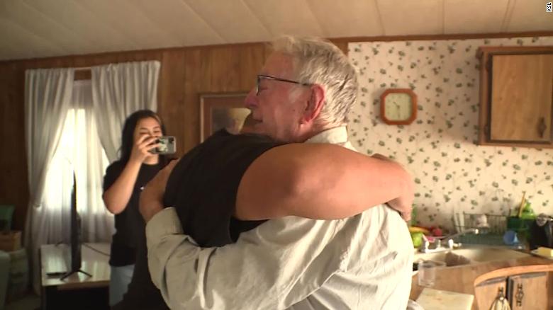 Derlin Newey, a pizza delivery driver in Utah, hugs the Valdez family after being surprised with a tip of a lifetime.