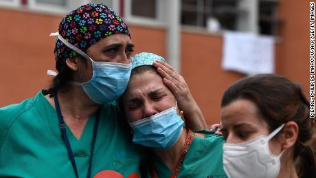 Healthcare workers acknowledge applause in memory of their co-worker Esteban, a male nurse who died of the coronavirus disease at the Severo Ochoa Hospital in Leganes, near Madrid, on April 10, 2020.