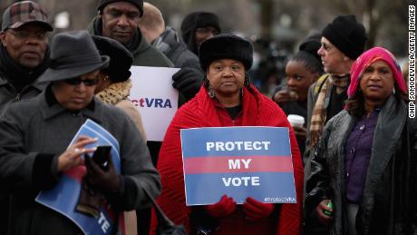 Alabama residents stand in line outside the US Supreme Court for the chance to hear oral arguments in Shelby County v. Holder on February 27, 2013, in Washington. 