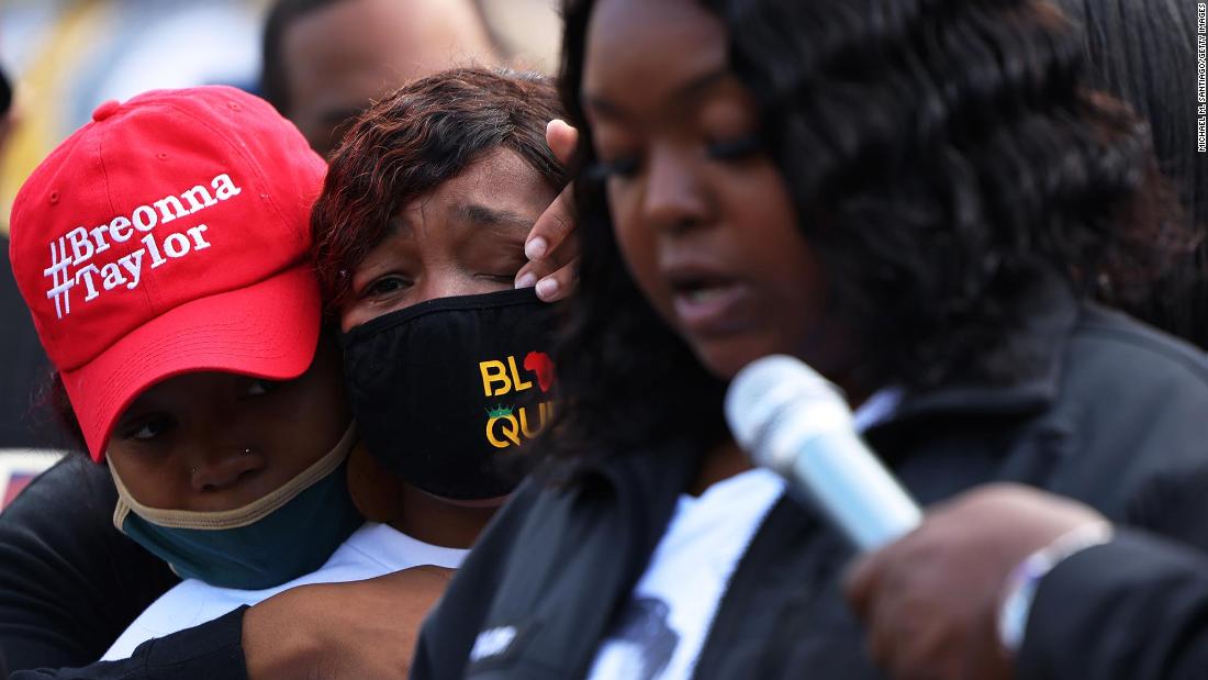 Ju&#39;Niyah Palmer, Breonna Taylor&#39;s sister, wipes away tears from the face of her mother Tamika Palmer, Breonna Taylor&#39;s mother, as Bianca Austin, the aunt of Breonna Taylor, speaks at a press conference in Jefferson Square Park in Louisville on September 25.