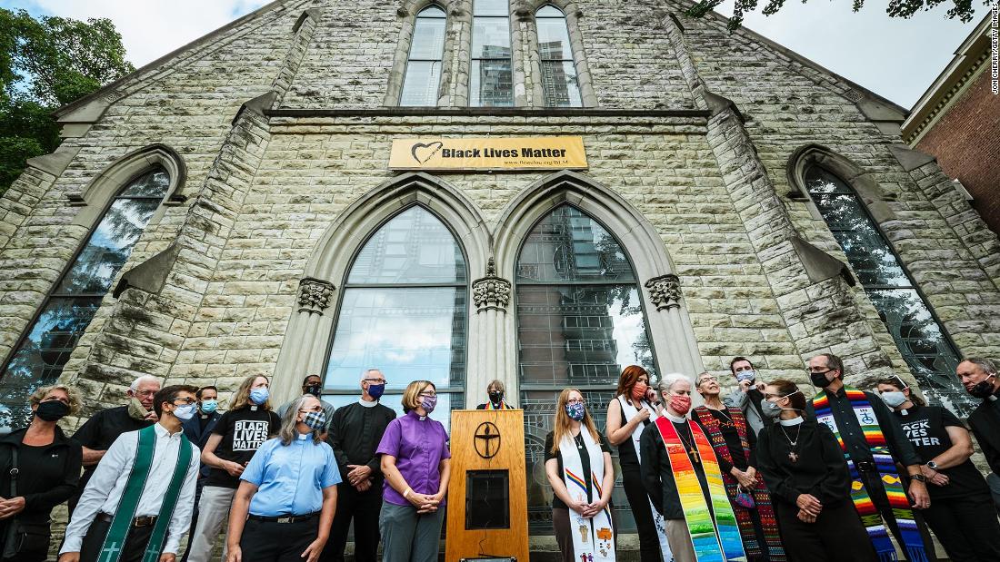 Religious leaders from around the city gather at a press conference in front of First Unitarian Church in Louisville on Friday, September 25. Leaders discussed the unrest and incident the previous night where police surrounded the church and threatened to detain anyone who attempted to exit the perimeter. 