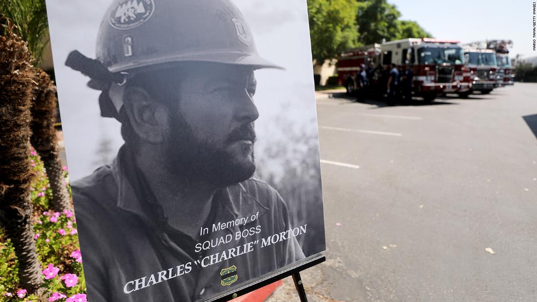 A photograph of Charles Morton, a firefighter killed battling the El Dorado Fire, is displayed at a memorial service in San Bernardino, California, on September 25. Morton, 39, was a 14-year veteran of the US Forest Service and a squad boss with the Big Bear Hotshot Crew of the San Bernardino National Forest.