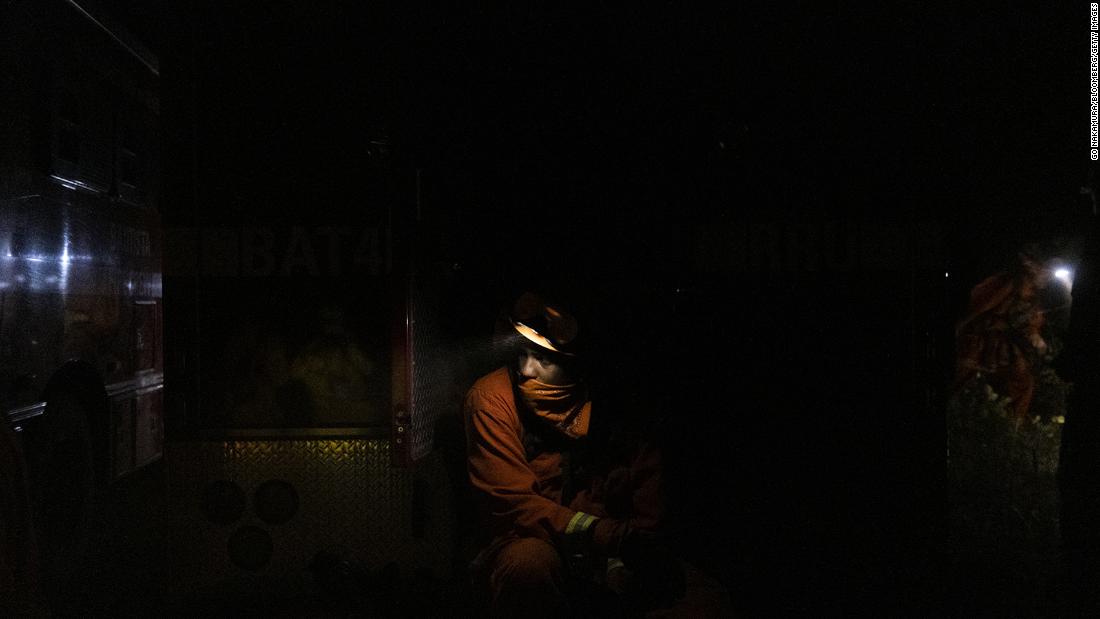 An inmate firefighter takes a break while working to contain the Bear Fire in Oroville, California, on September 24.