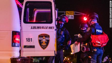 Police officers put a protester in the back of a van on Saturday in Louisville. 