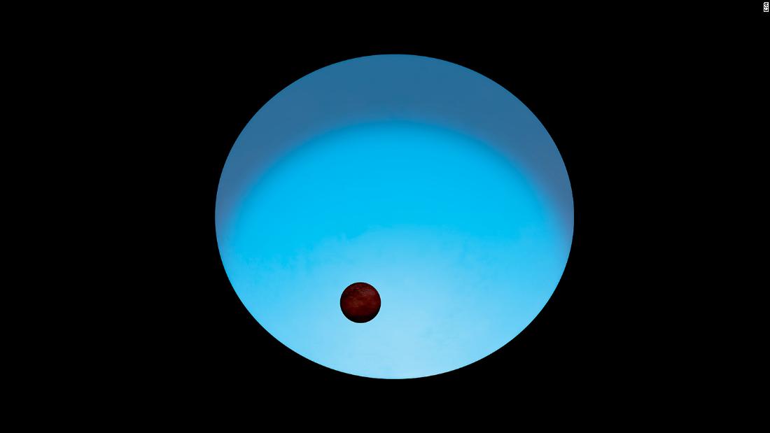 This is an artist&#39;s impression of exoplanet WASP-189 b orbiting its host star. The star appears to glow blue because it&#39;s more than 2,000 degrees hotter than our sun. The planet, which is slightly larger than Jupiter, has a tilted orbit around the star&#39;s poles rather than its equator.