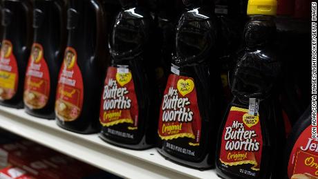 Mrs. Butterworths products seen displayed on supermarket shelves.