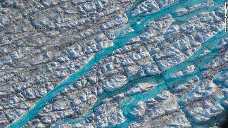 ILULISSAT, GREENLAND - AUGUST 04: In this view from an airplane rivers of meltwater carve into the Greenland ice sheet near Sermeq Avangnardleq glacier on August 04, 2019 near Ilulissat, Greenland. The Sahara heat wave that recently sent temperatures to record levels in parts of Europe has also reached Greenland. Climate change is having a profound effect in Greenland, where over the last several decades summers have become longer and the rate that glaciers and the Greenland ice cap are retreating has accelerated.   (Photo by Sean Gallup/Getty Images)