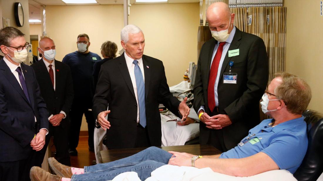 Pence visits Dennis Nelson, a patient who survived the coronavirus and was going to give blood, during a tour of the Mayo Clinic in Rochester, Minnesota, in April 2020.  Pence chose not to wear a face mask during the tour despite the facility&#39;s policy. Pence initially told reporters that he wasn&#39;t wearing a mask because he&#39;s often tested for coronavirus. He later said he should have worn one.