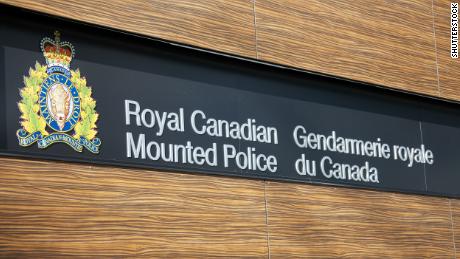  A sign for the Royal Canadian Mounted Police in English and French along with the crest of the RCMP.
