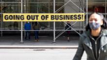 A woman wearing a mask walks by a &quot;going out of business&quot; sign as the city continues Phase 4 of re-opening following restrictions imposed to slow the spread of coronavirus on September 20, 2020 in New York City. The fourth phase allows outdoor arts and entertainment, sporting events without fans and media production. (Photo by Alexi Rosenfeld/Getty Images)