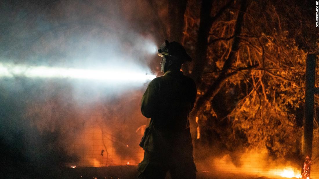 Firefighter Abraham Garcia signals a water truck in Angwin, California, on September 29.