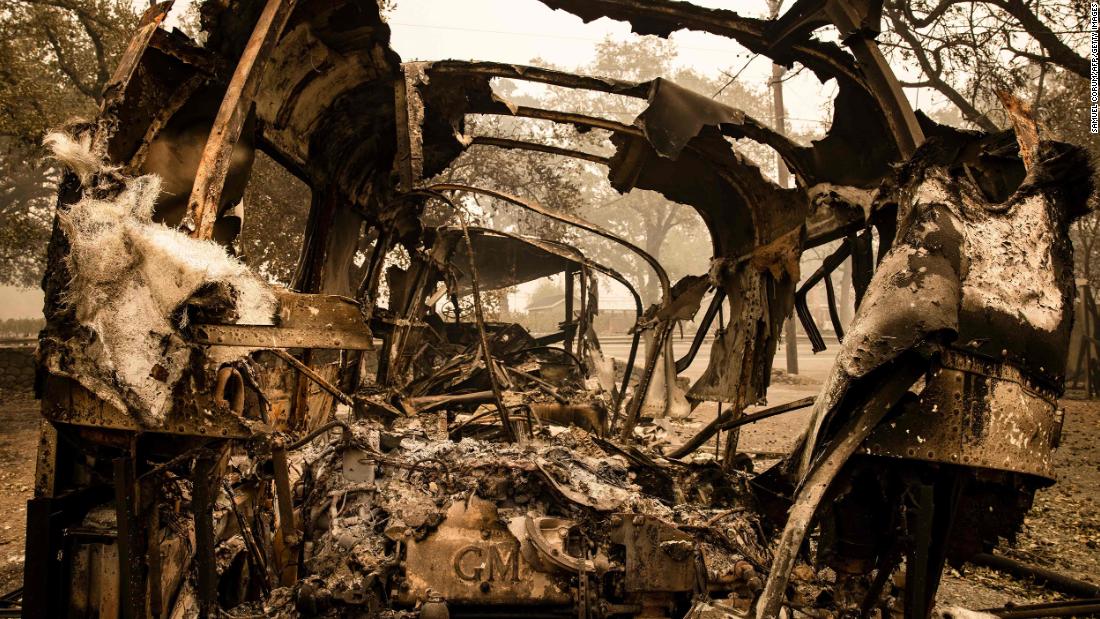 Vehicles burned in the Glass Fire sit outside of a home that survived in Calistoga on September 30.