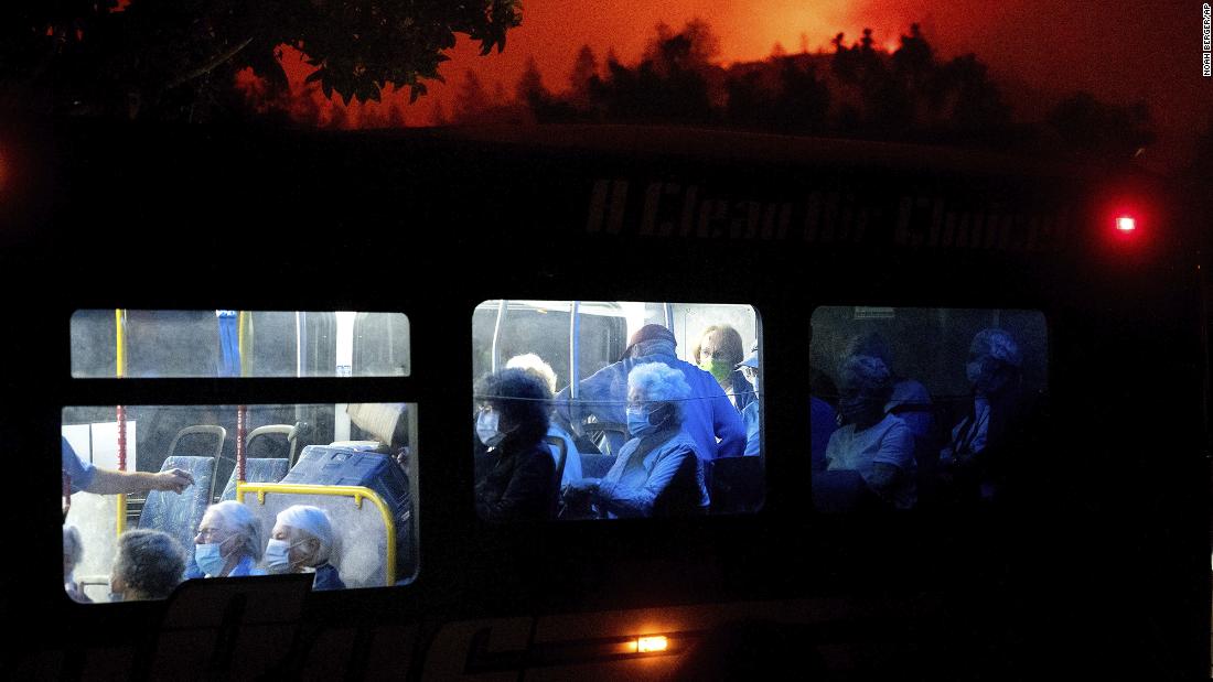 Residents of the Oakmont Gardens senior home are transported to safety as the Shady Fire approaches in Santa Rosa on September 28, 2020.