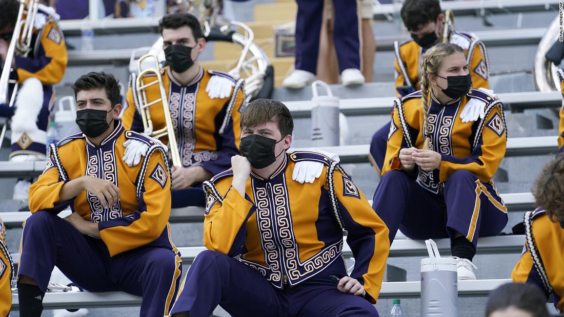 Members of the LSU marching band sit apart from one another before a college football game in Baton Rouge, Louisiana, on September 26.