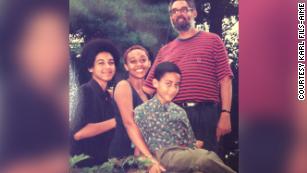 Fils-Aimé standing with his three children, Karl, Gerard and Erica. 