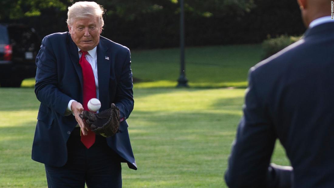 Trump plays catch with former New York Yankees pitcher Mariano Rivera as he greets youth baseball players on the South Lawn of the White House in July 2020.