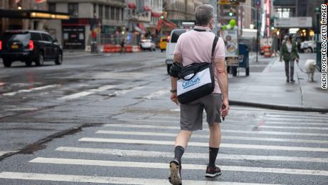 A US Census worker walks across the street as the city continues Phase 4 of re-opening following restrictions imposed to slow the spread of coronavirus on September 29, 2020 in New York City. The Census is scheduled to end on October 31.