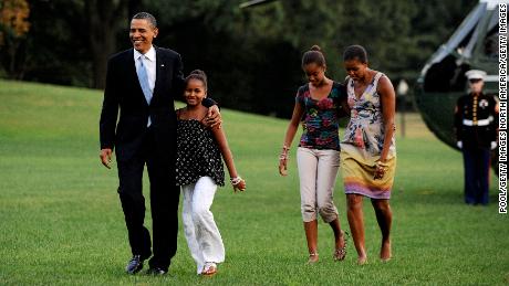 Barack and Michelle Obama return from vacation with daughters Sasha (left) and Malia in August 2010.