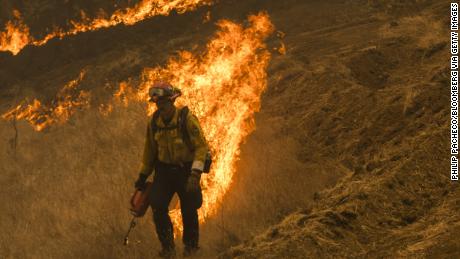 A firefighter ignites a controlled burn during the Glass Fire near Calistoga Friday.