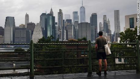 NEW YORK, NEW YORK - SEPTEMBER 29: A man looks out at the Manhattan skyline in a Brooklyn neighborhood on September 29, 2020 in New York City. New York City faces a severe financial crisis as unemployment has risen to 16% and thousands of wealthy residents who make up a vital tax base have fled the city. New York City lost 24,000 residents to Coved-19, more than any other city in America and one of the highest metropolitan losses in the world. Vital sectors like tourism, retail and cultural activities are still struggling as the city attempts to get past the epidemic. (Photo by Spencer Platt/Getty Images)