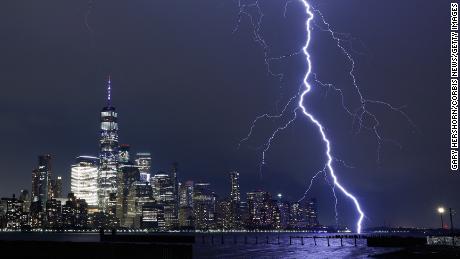 A bolt of lightning strikes next to lower Manhattan in New York during a thunderstorm on August 27.
