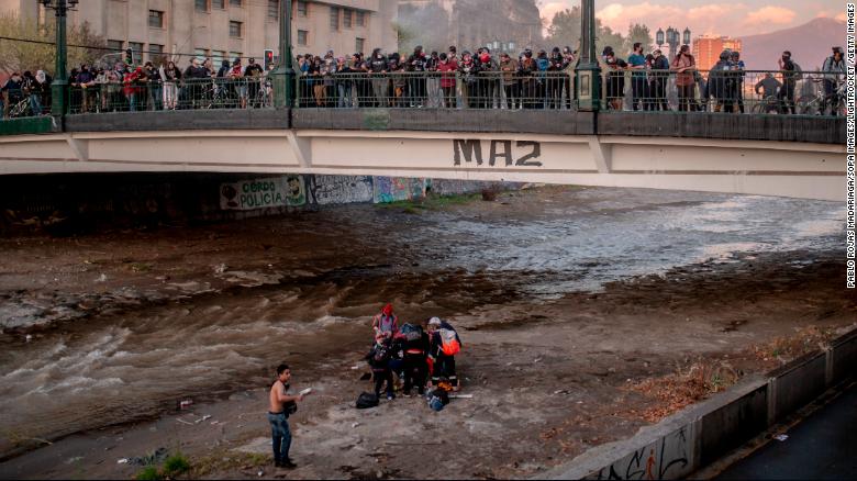 Officer detained for allegedly throwing boy off bridge at a protest in Chile
