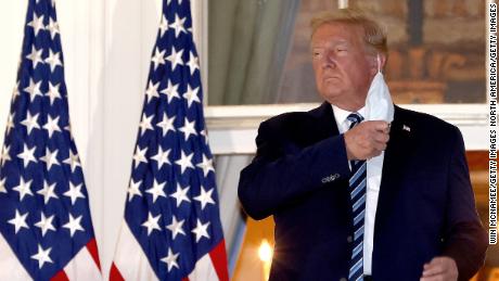 US President Donald Trump removes his mask on his return to the White House from Walter Reed National Military Medical Center, where he was treated for coronavirus.