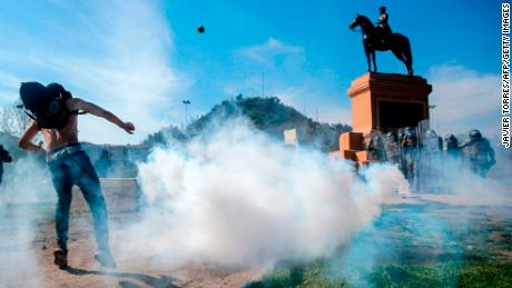 Demonstrators clash with riot police during a protest in Santiago on Saturday.