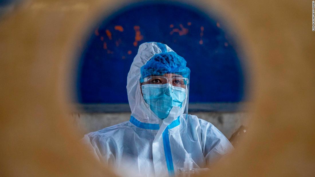 A health worker in Manila, Philippines, sits behind a booth October 6 during mass testing for public transportation drivers. 