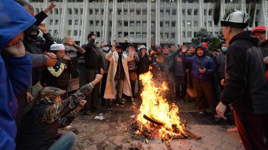 Люди, протестующие против результатов выборов, собираются во вторник у костра перед главным правительственным зданием, известным как Белый дом, в Бишкеке.