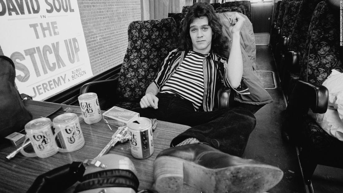 Eddie Van Halen sits in the band&#39;s tour bus outside the Lewisham Odeon on May 27, 1978. On the table are cans of Colt 45, matches and a replica hand gun.