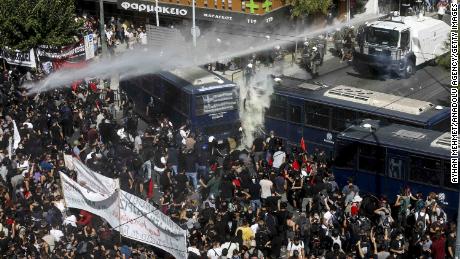 Riot police used water cannon during clashes with anti-fascist protesters after the Golden Dawn leadership was found guilty in Athens on Wednesday.