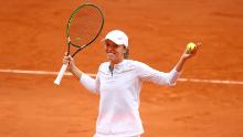 Swiatek reacts after winning match point in her French Open semifinal.