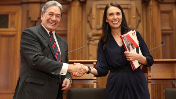 Prime Minister-designate Jacinda Ardern and New Zealand First leader Winston Peters shake hands during a coalition agreement signing at Parliament on October 24, 2017, in Wellington. For weeks after the country's 2017 general election, there was no clear victor, with neither major party winning an outright majority.