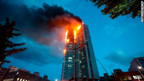 An apartment building is engulfed in a fire in Ulsan, South Korea, on October 9.