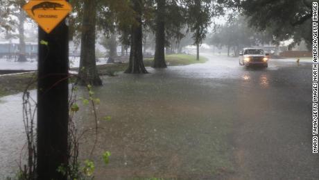 A truck drives through standing water Friday in Lake Arthur, Louisiana.