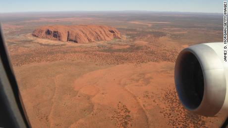 ULURU, AUSTRALIA - OCTOBER 10: Qantas flight number QF787, a Boeing 787 Dreamliner aircraft flies close to Uluru in the Uluru-Kata Tjuta National Park, Northern Territories on October 10, 2020 in Uluru, Australia. With international and domestic border closures due to the COVID-19 pandemic putting a halt on travel, the Qantas Great Southern Land Scenic flight will take 150 passengers on an aerial tour over iconic Australian destinations. The seven-hour scenic flight on board a Qantas 787 Dreamliner aircraft - usually used for long haul international flights - will perform a loop from Sydney up to locations along the New South Wales and Queensland coasts as well as Uluru in the Northern Territory before landing back in Sydney. (Photo by James D. Morgan/Getty Images)