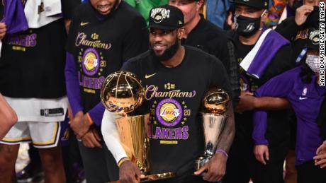 LeBron James celebrates after receiving the Bill Russell Finals MVP Trophy and the Larry O&#39;Brien Trophy after Game Six of the NBA Finals on Sunday.