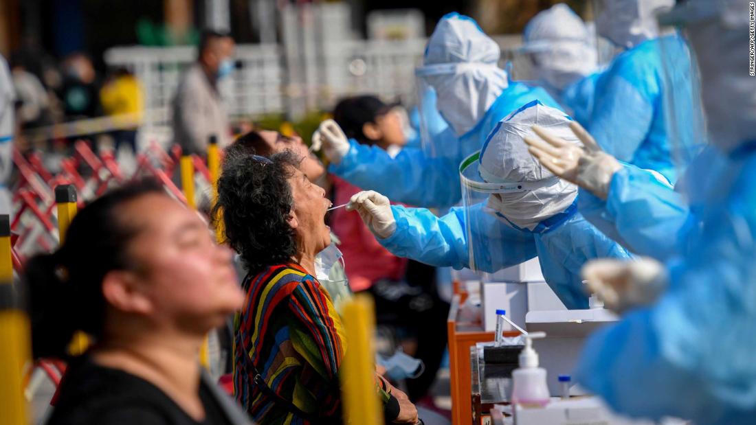 A health worker takes a swab from a resident at a Covid-19 testing center in Qingdao, China, on October 12. The Chinese port city planned to &lt;a href=&quot;http://edition.cnn.com/2020/10/12/asia/china-qingdao-coronavirus-golden-week-intl-hnk/index.html&quot; target=&quot;_blank&quot;&gt;test some 9 million people&lt;/a&gt; in the following days after 12 locally transmitted cases were reported.