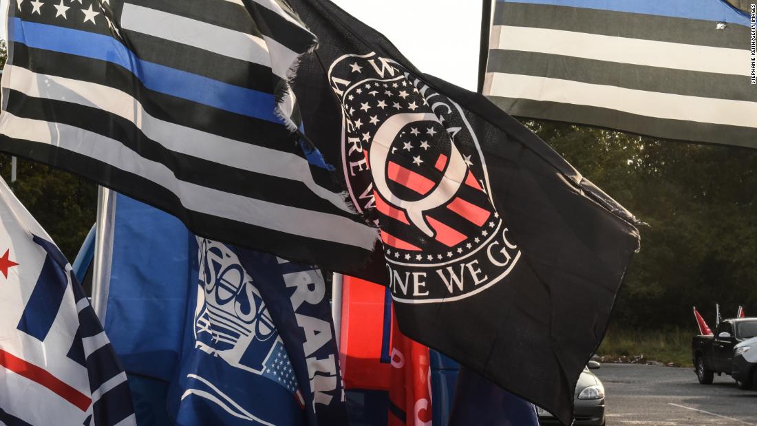 A QAnon flag is flown during a rally in support of President Trump on October 11, 2020 in Ronkonkoma, New York. 