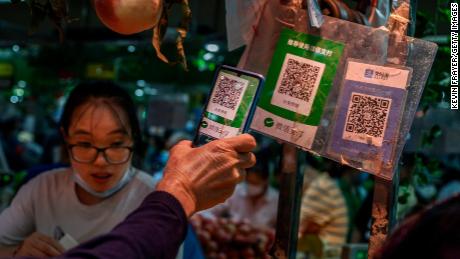 A Chinese customer using his phone to pay via a QR code with the WeChat app at a market in September in Beijing.