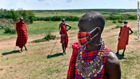 Cultural performers from the Maasai tribe wear masks in the Maasai Mara National Reserve, where their work of performing for visiting tourists has dwindled. 