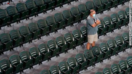 A fan watches batting practice and player warmups from the stands prior to Game 1 of the NLCS between the Braves and the Dodgers.