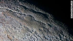 Pluto&#39;s snow-capped mountains look like they belong on Earth, but they&#39;re entirely different