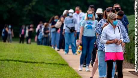 FAIRFAX, VIRGINIA - SEPTEMBER 18: People stand on line,  spaced six apart due to COVID-19, in order to vote early at the Fairfax Government Center on September 18, 2020 in Fairfax, Virginia. Voters waited up to four hours to early vote in the upcoming 2020 presidential election, polls opened at 8am, and people where in line at 5:45am according to poll workers. (Photo by Tasos Katopodis/Getty Images)