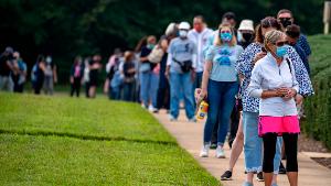 FAIRFAX, VIRGINIA - SEPTEMBER 18: People stand on line,  spaced six apart due to COVID-19, in order to vote early at the Fairfax Government Center on September 18, 2020 in Fairfax, Virginia. Voters waited up to four hours to early vote in the upcoming 2020 presidential election, polls opened at 8am, and people where in line at 5:45am according to poll workers. (Photo by Tasos Katopodis/Getty Images)